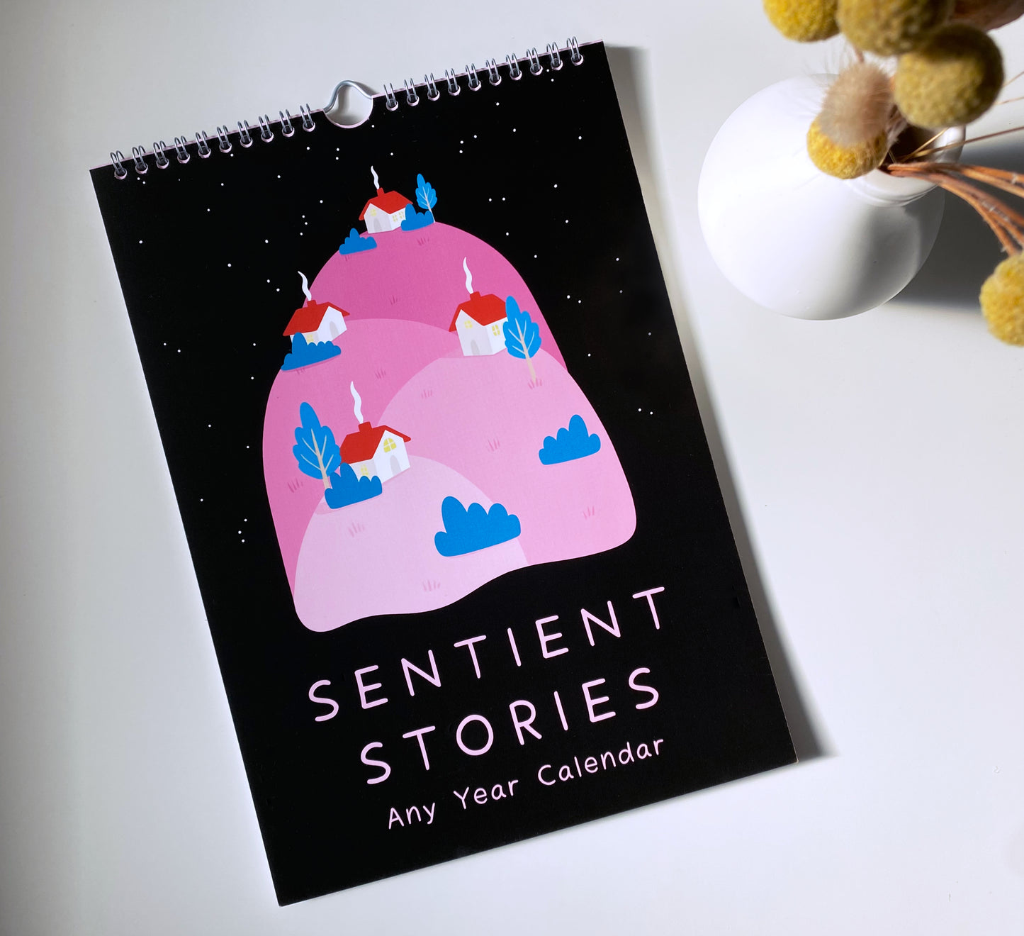 Calendar with 'Sentient Stories' design on a white surface
