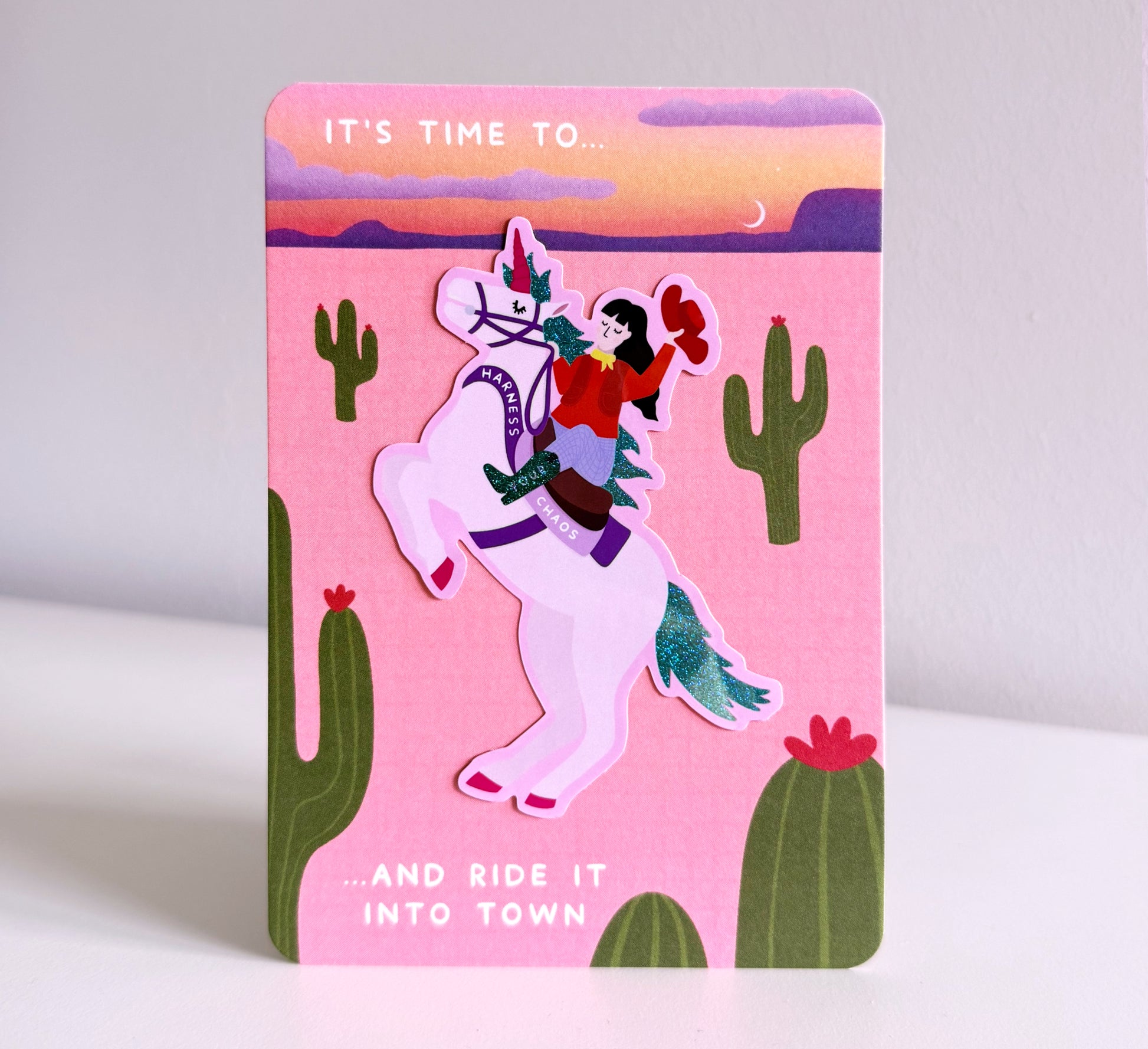 Sparkly sticker of a cowgirl riding a unicorn that says 'Harness Your Chaos' - and ride it into town. Self-love, ADHD. Neurodivergent, Neurosparkly, self-acceptance, healing, power, strong woman, gift for strong women, empowering, gift for friends.